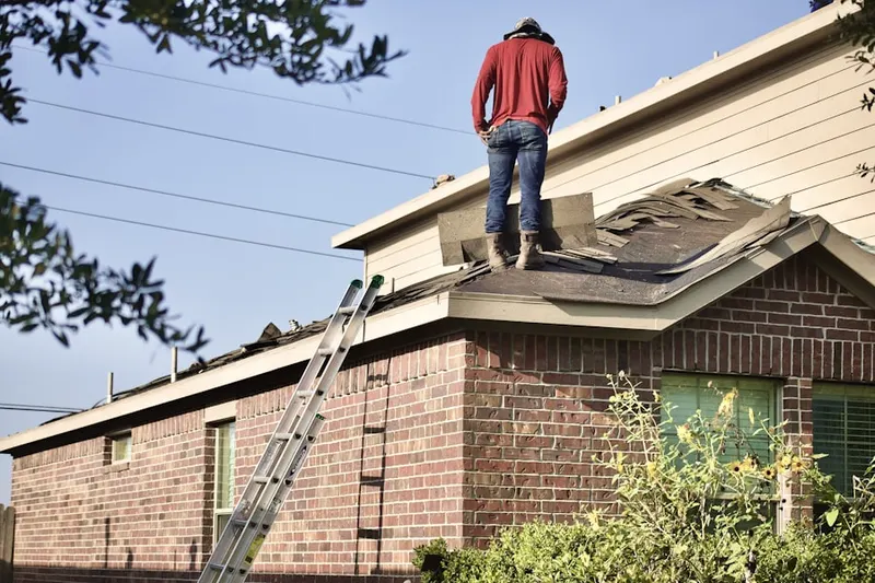 Professional roofer working on a residential roof in The Thicket